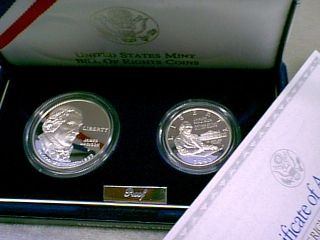 silver dollar portraiting james madison and a silver proof half dollar